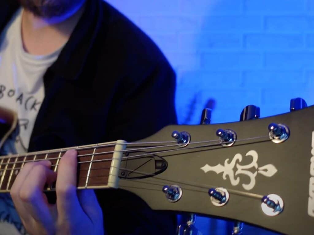 photo of man playing on ibanez as53