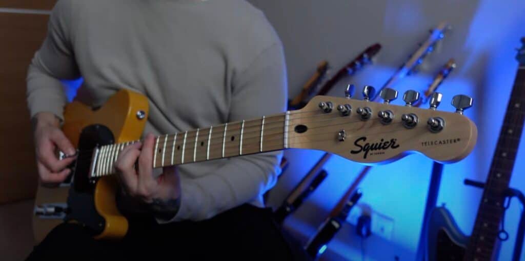 guitarist playing on squier sonic telecaster